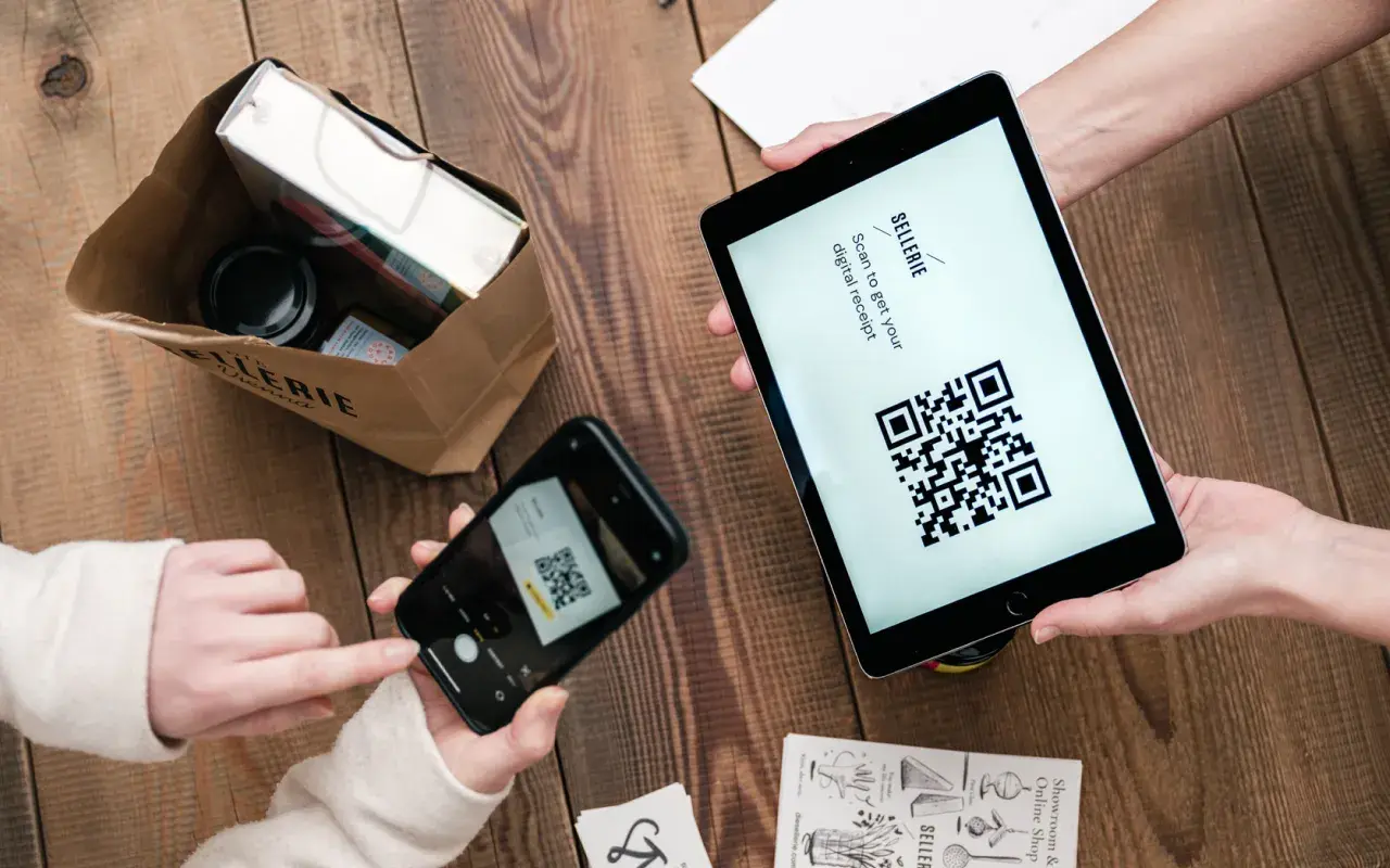 A person takes a picture of the QR code to complete the payment
