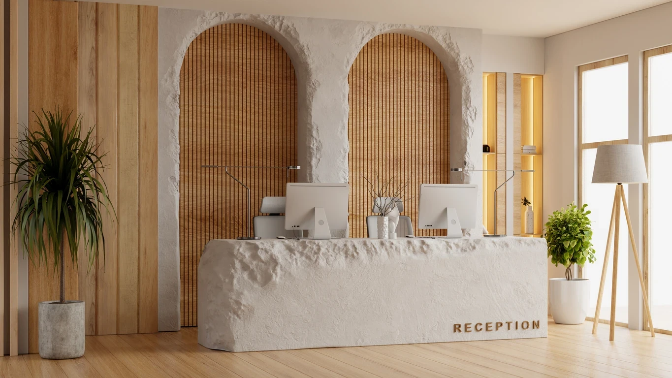 Modern hotel reception desk with stone counter and wood wall accents